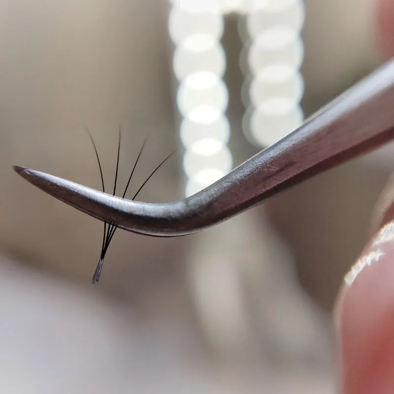 Volume lash extensions — Lash artist applying eyelash extensions to a client
